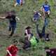 Cheese Roll competitors running and falling down large hill